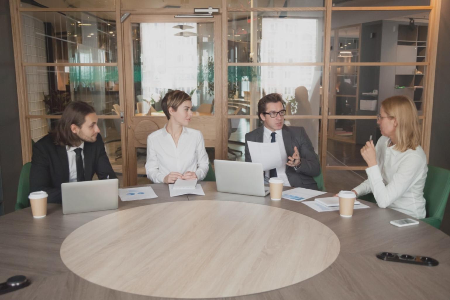 Business professional analyzing financial documents and market research data