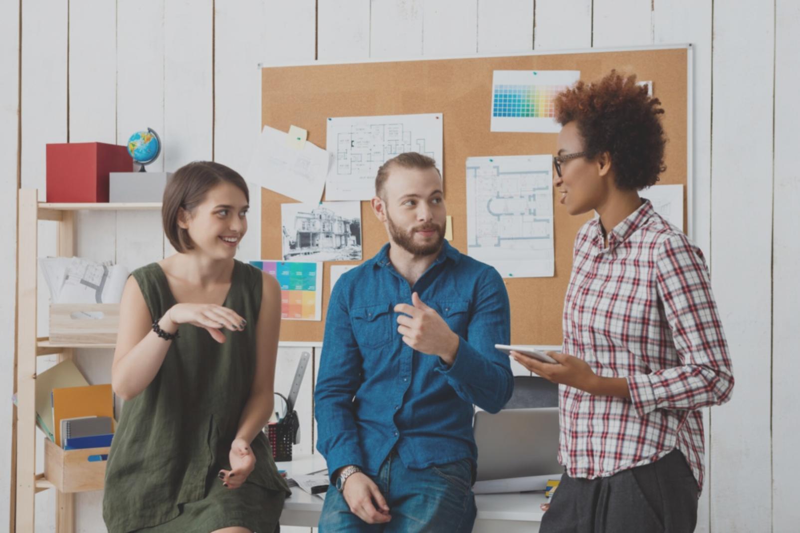 Small business owner analyzing financial reports at desk with calculator and documents